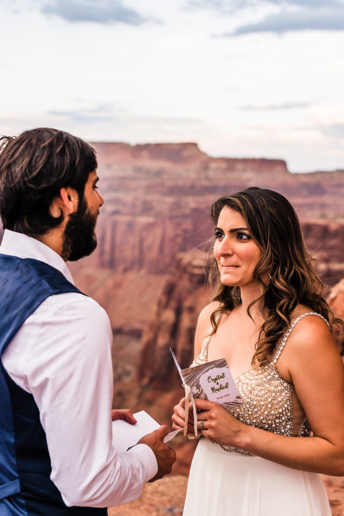Wedding ceremony in Moab. The bride looks emotional as she hears her husband's vows.
