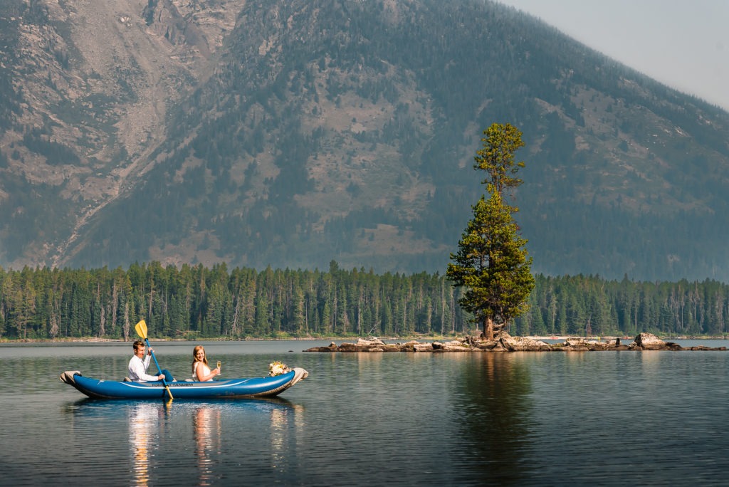 Kayaking wedding. A couple row across a lake to a tiny private island.