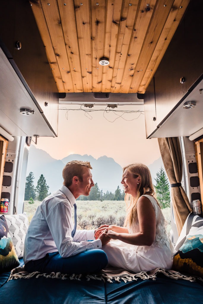 The couple relax in the back of their camper van as the sun is about to set and they get ready to reshare their vows.