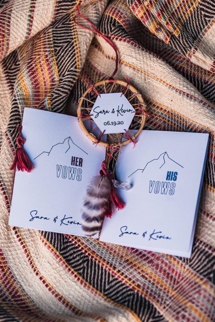Handmade vow books with mountains and a good luck dream catcher.