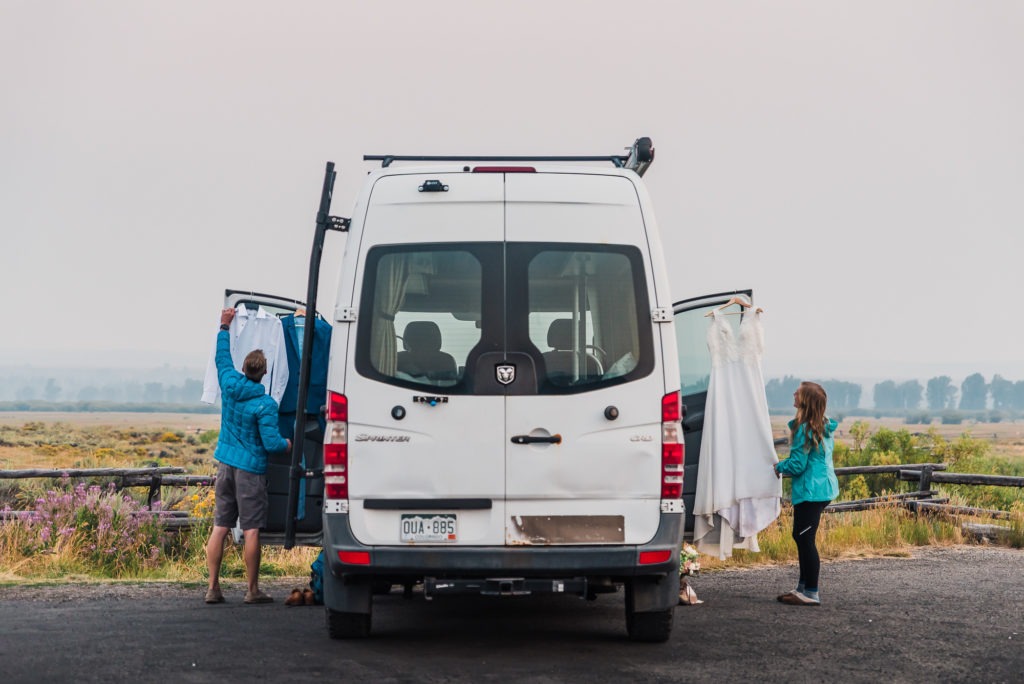 A couple get ready opposite sides of their van in preparation for a sunrise first look.