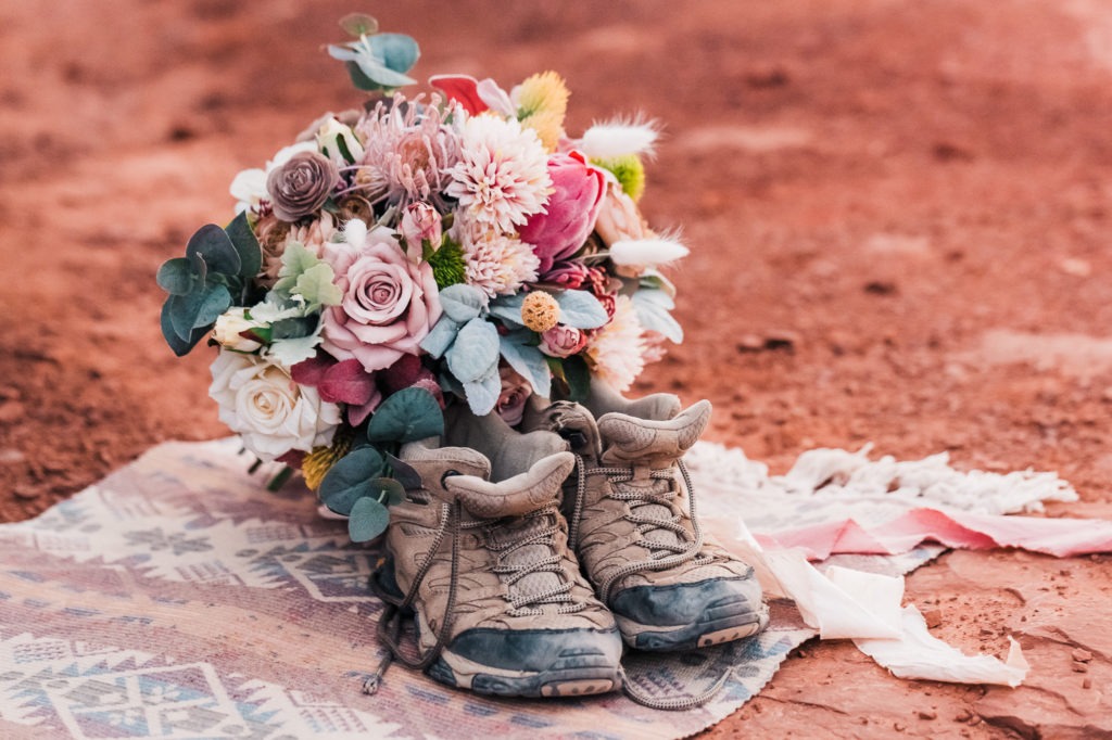 Hiking wedding. The bride's bouquet rests inside her hiking boots.