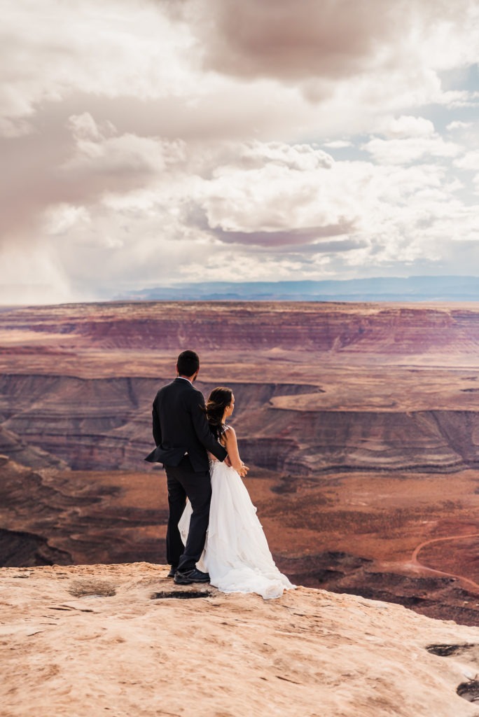Moab wedding. The couple look out over the canyons.