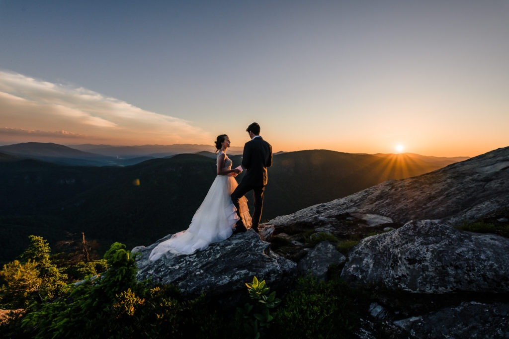 Sunset elopement. The sun is just about to disappear behind the mountains as the couple finish sharing their vows.