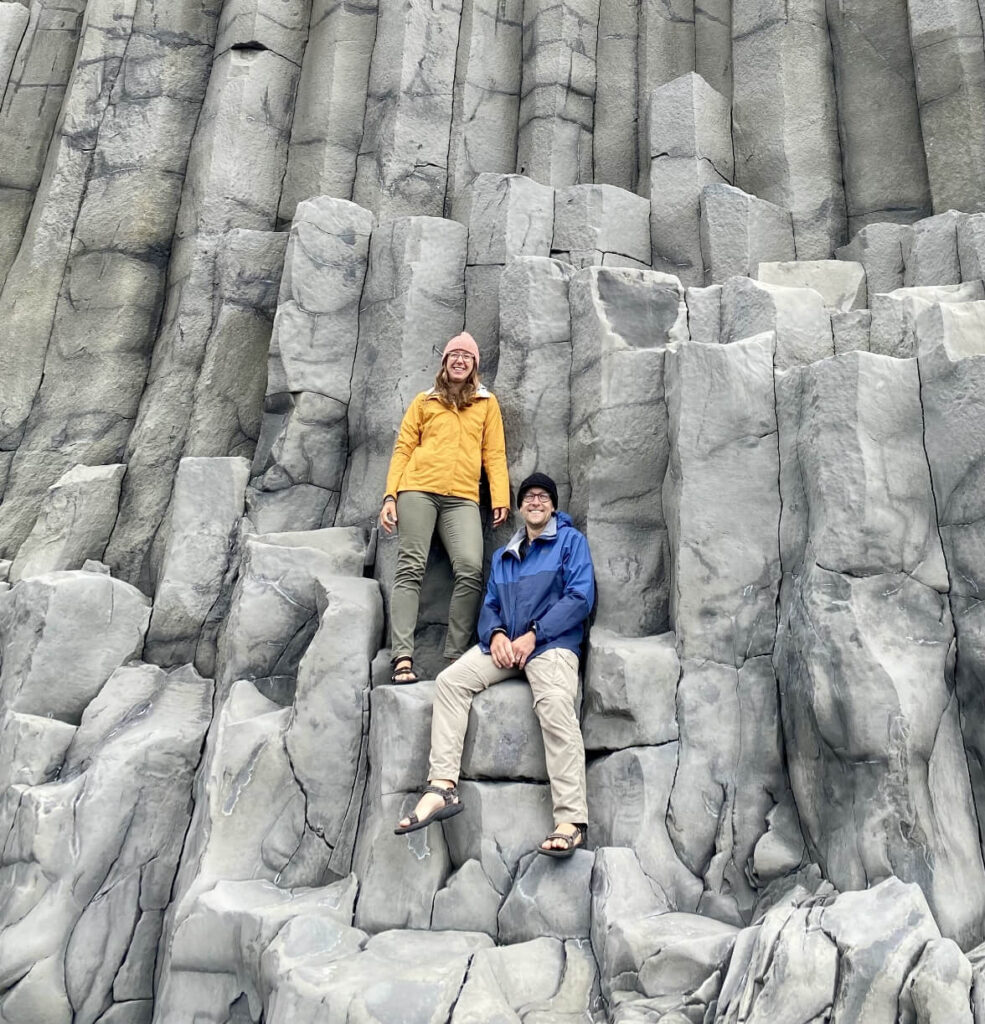 Vanessa and Chad pose on a rocky outcliff.