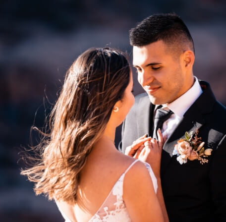 A couple leans into one another, smiling.